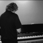 "Arms of Love" - Ron Setting Up Piano